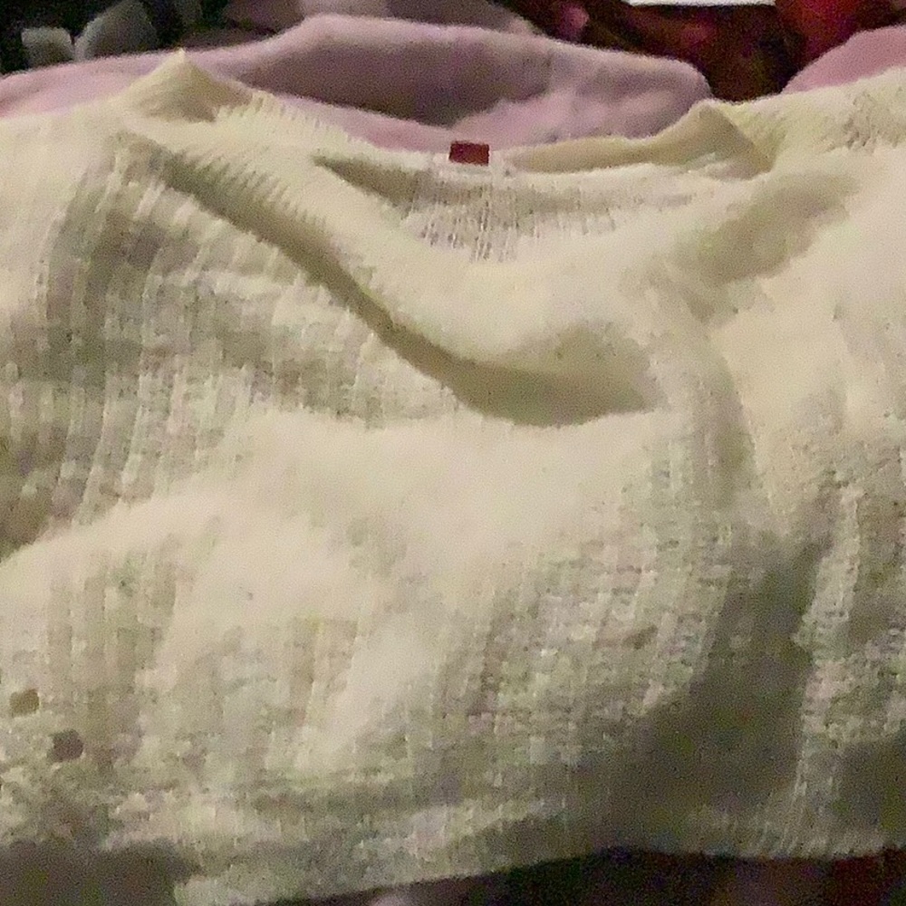 A white shirt that fits loosely and appears as a tank top.